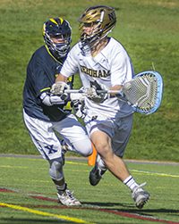 Goalie Ryan Christenson avoids a Xaverian defender behind the goal. Photos by Tim Hoffman