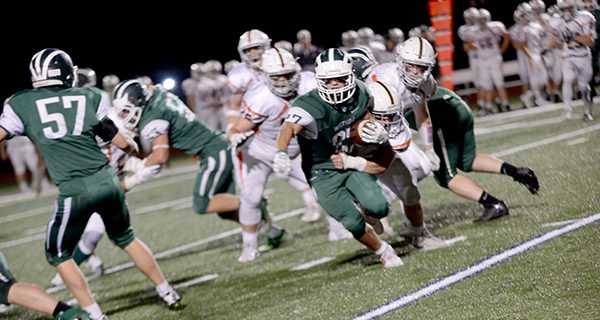 Brendan Delaney (53) and Bob Maughn (57) set blocks as running back Rob Antonucci (27) breaks a tackle and attempts to get to the edge on a power run play late in the second quarter.