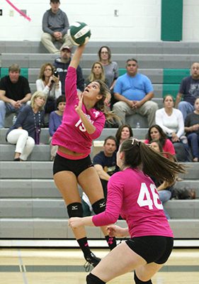 Camille Cummings (3) sports the number 15 on Monday night for Westwood and saves a point for the Wolverines with an athletic play during the second set. Photos by Michael Mao