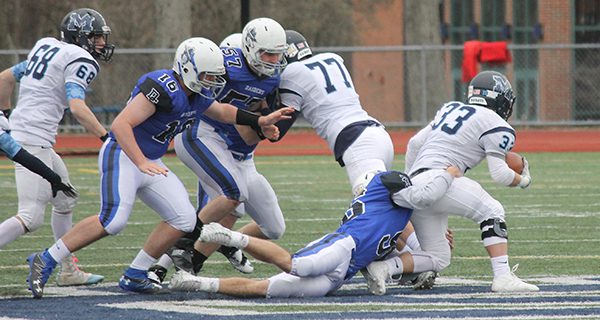 Raider defensive end Joe Beninati (56) stuffs Medfield’s Mason Giunta (33) at the line of scrimmage for no gain. Photo by Michael Flanagan