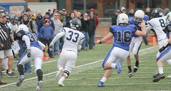 Running back Mason Giunta (33) breaks loose up the sideline for a large Warrior gain early in the second half. Photo by Michael Flanagan