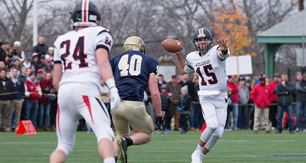 Wellesley quarterback Jack Tishman (15) scrambles and looks downfield on a dump off to wideout Scott Westerman (24). Photos by Alison Borrelli