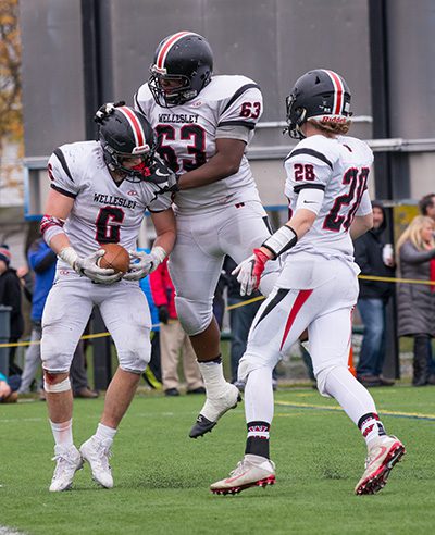 Grant Chryssicas (6) celebrates his second touchdown of the day with teammates Jason Maiona (28) and Gus St. Fort (63). Photos by Alison Borrelli