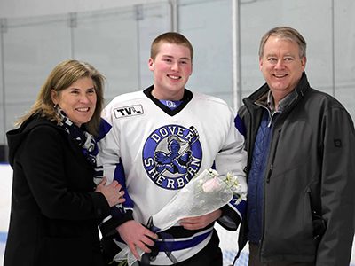 Senior goaltender Owen Webb poses with his parents on senior night before earning a 22-save shutout in DS’s 2-0 victory over Worcester/Leicester on Saturday.