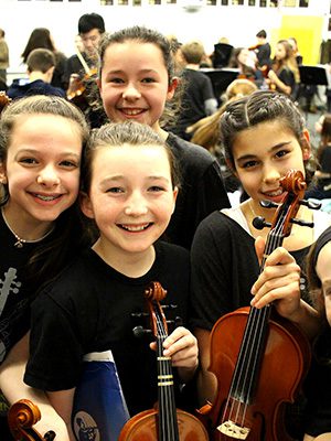 Several Medfield Strings Orchestra members include (left to right) Zoe Whelan, Bridget Taris, Gabby Curl. Photos by Geena Matuson