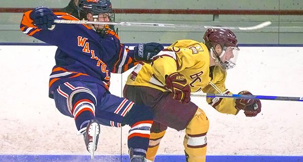 Senior forward Cam Martin (17) collides with a BC High defender in game two of Walpole’s quarterfinal series against the Eagles. Photos by Tim Hoffman