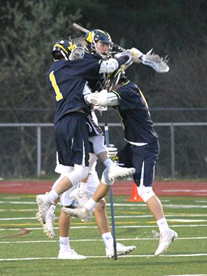 Jared Grier and a band of Hawks celebrate Xaverian’s fourth goal of the first quarter to go ahead by three on Medfield. Photos by Michael Flanagan