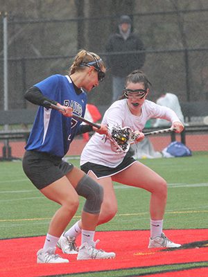 DS’s Ali Jordan (7) gets set up at centerfield before winning a faceoff early in the second half. Photos by Michael Flanagan