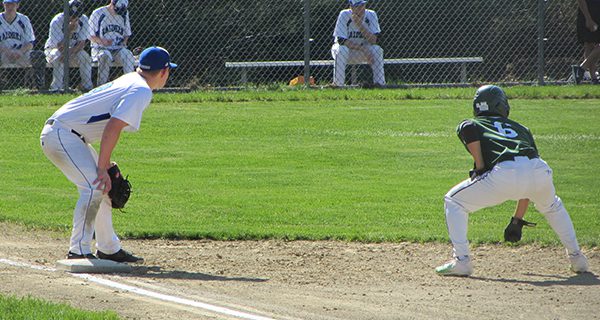 DS’s Ryan Sliwinski (19) holds Westwood’s Mark Bernardo (6) at first base in the top of the third inning. Photos by Michael Flanagan