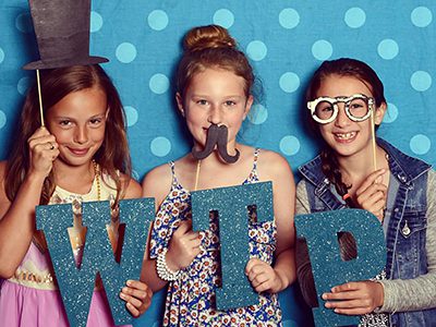 From left to right: Students Kate Morrow Bebe Cloaninger, and Payton Defina pose in the photo booth. Photos by John Harmon of Sandy Sandwich Productions