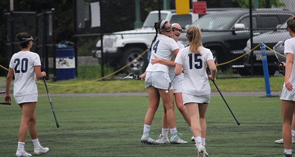 Kendall Milligan (14), Maeve Barker (15), Stephie Vallace (20) and a group of Rockets celebrate Needham’s sixth goal of the game midway through the first half. Photos by Michael Flanagan