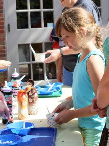 Visitors at the ice cream social, hosted by the Dover Town Library, choose toppings for their sweet treat.