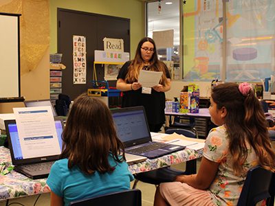 A small group of girls interested in computer science meets with Children’s Librarian, Veronica McCarthy, at the first session of Girls Who Code. Photos by Laura Drinan