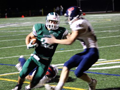 Senior captain Jake Antonucci (22) gets ready to unload a hit stick and punch the ball into the end zone for a 14-12 Westwood lead late in the third quarter. Photos by Michael Flanagan