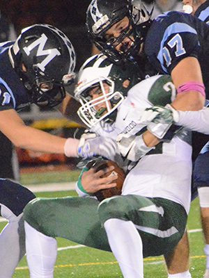 A helmetless Mason Giunta (33) helps corral Westwood’s Jake Antonucci (22) with the help of teammates John Lowell (77) and Elliott Mantz (81).