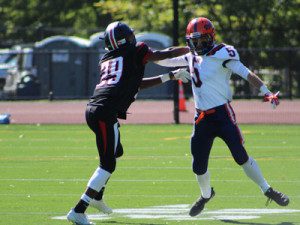 Wellesley defensive back D’Aunte Moore (29) and Walpole wideout Andrew White (5) become acquainted with one another early in the second quarter.