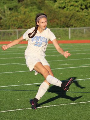 Senior defender Maggie Hurley (23) boots the ball up the field on a free kick. Photos by Michael Flanagan