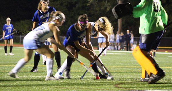 Dover-Sherborn’s Haley Gladstone (1) fights off a gang of Warrior defenders for a rebound midway through the second half on a Raider corner attempt. Photos by Michael Flanagan