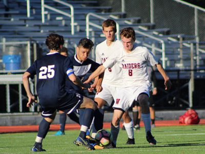 Owen DeOliveria (6) and Ryan Clare (8) battle with a pair of Framingham defenders for a loose ball late in the first half.