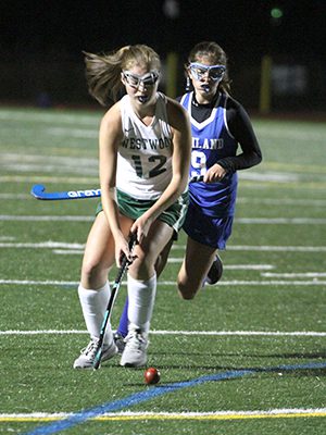 Hannah Medsker (12) moves the ball up the field for Westwood late in the second half. Photos by Michael Mao