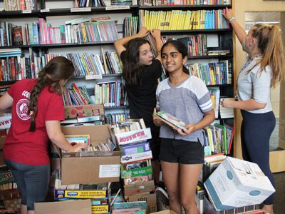 A group of volunteers sort and pack books to send to Houston elementary schools that lost their entire library collection as a result of Hurricane Harvey. Photos by Laura Drinan