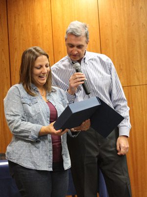 Peter DiMarzio of the Department of Homeland Security, presents sex trafficking survivor, wife, mother, and author, Jasmine Grace Marino, with the “Outstanding Outreach Award.”