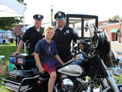 Seven-year-old Will Owens tests out a Needham Police Department motorcycle at the Needham Business Association’s Harvest Fair.