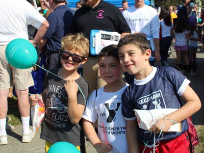 Will Reservitz, Simon Bright, and Ethan Bright, enjoy the annual fair with balloons and other treats from local businesses.