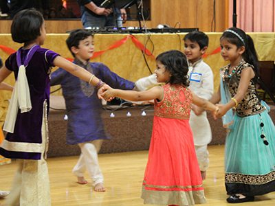 Children under five-years-old join hands for a choreographed dance to start the evening’s Diwali festivities. Photos by Laura Drinan