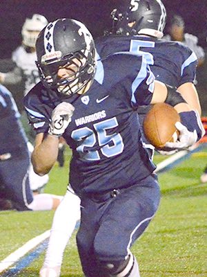 Medfield running back Joe Vachon (25) tries to bump a run to the outside with Westwood’s Dominic Hough (32) and Michael Hanlon (5) in pursuit.