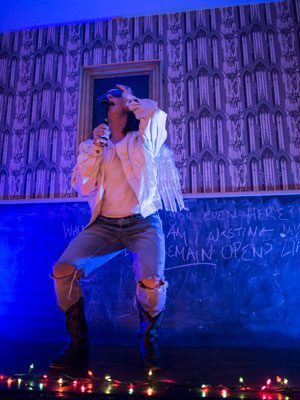 Richard, played by Madeline Bugeau-Heartt, drunkenly sings karaoke in Bugeau-Heartt’s production of ‘A Crack of Strange Light.’