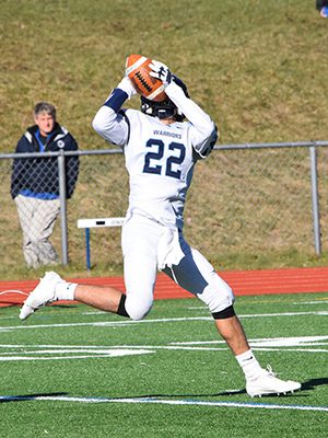 Medfield senior captain and wideout Liam O’Toole hauls in a deep ball before dashing 59-yards to the end zone for the Warriors’ second touchdown of the afternoon on Thanksgiving. Photos by Lizzy Collotta