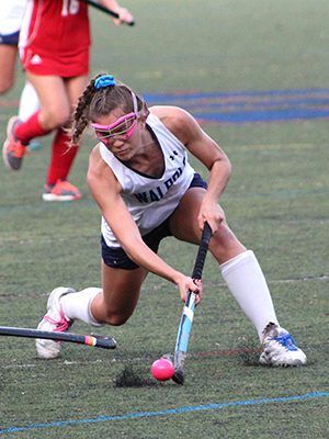 Audra Tosone (3) avoids a stick-check from a North Attleboro defender and unleashes a shot on net late in the first half. Photos by Michael Flanagan