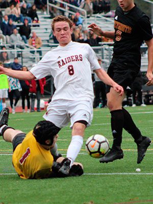 Ryan Clare (8) tries to navigate the ball through a diving Weymouth goalkeeper and a pursuing Wildcat defender late in the first half.