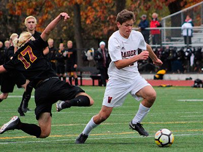 P.J. Genta (22) avoids a slide tackle and moves in for a shot on goal midway through the second half.