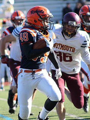 Walpole running back Chris Reilly (49) avoids tacklers and attempts to get to the outside on a toss play early in the second half. Photos by Michael Flanagan