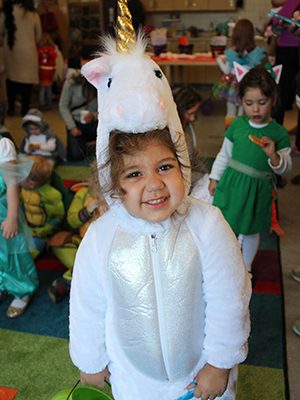 Three-year-old Lara begins her day of Halloween fun at the Westwood Library’s Halloween sing-along, parade, and party. Photos by Laura Drinan