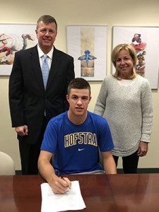 Timmy Hall (middle), who’s brother Bobby plays hockey at Babson, poses with his parents after signing his NLI to play golf at Hofstra on Wednesday and becoming the second Hall sibling to play a sport in college.