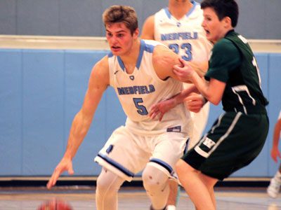 Medfield forward Mitchell Gonser (5) moves the ball up the floor past a Westwood defender before driving to the basket for two of his 14 points on Tuesday night.