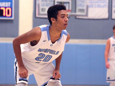 Medfield forward Christian Higgins (20) gets ready to rush into the paint for a potential rebound on a free throw attempt late in the game.
