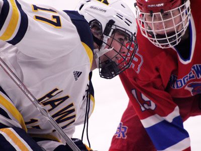 Freshman forward Robbie Barletta (17) takes a defensive zone draw late in the first period. Photos by Michael Flanagan