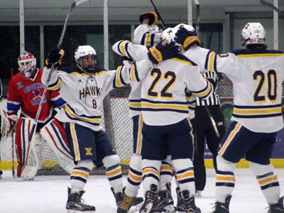 Eric Wainwright (8) and teammates gather together to celebrate Trevor Connolly’s game and season-opening goal for the Hawks just 3:30 into Monday’s contest against Bridgewater-Raynham. Photos by Michael Flanagan
