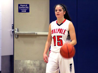 Point guard Sydney Scales (15) moves the ball up the floor and calls out a play for Walpole early in the first quarter.