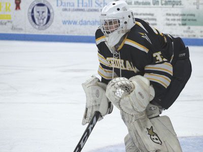 Needham goaltender and senior captain Dylan Jones (35) keeps an eye out and protects the near side of the cage late in the first period.