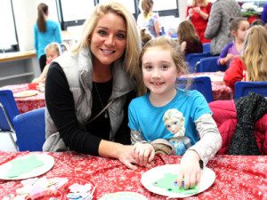 Isabella, a first grader at OPR, celebrates her first Gingerbread Festival making ornaments in the art room and participating in the annual event’s other activities.