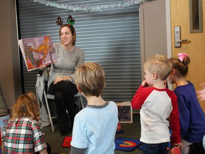 Westwood Public Library’s Lizzy McGovern holds a storytime for children at Winterfest, bringing a selection of festive picture books to inspire holiday cheer. Photos by Laura Drinan