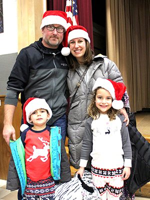 With their Santa hats on, the Carberry family spends an evening at Old Post Road’s annual sing-along to get excited for the holidays. Photos by Laura Drinan