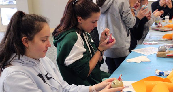 At the library’s revamped Friday hang-out program, Westwood teens create a glittery unicorn ornament.
