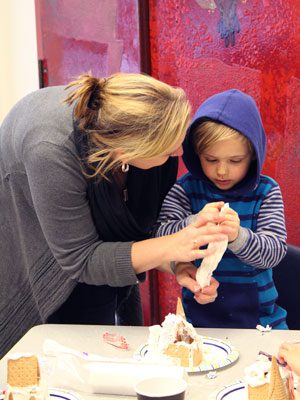 The Wellesley Free Library’s gingerbread house decorating event serves as a bonding experience for parents and children, without the mess in their own kitchen to worry about.