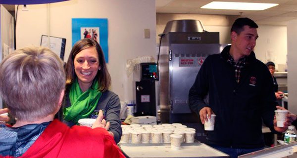 Registered Dietitian Jill Read and Dairy Farmer Jimmy Hunt serve hot chocolate milk to students at Pollard Middle School.